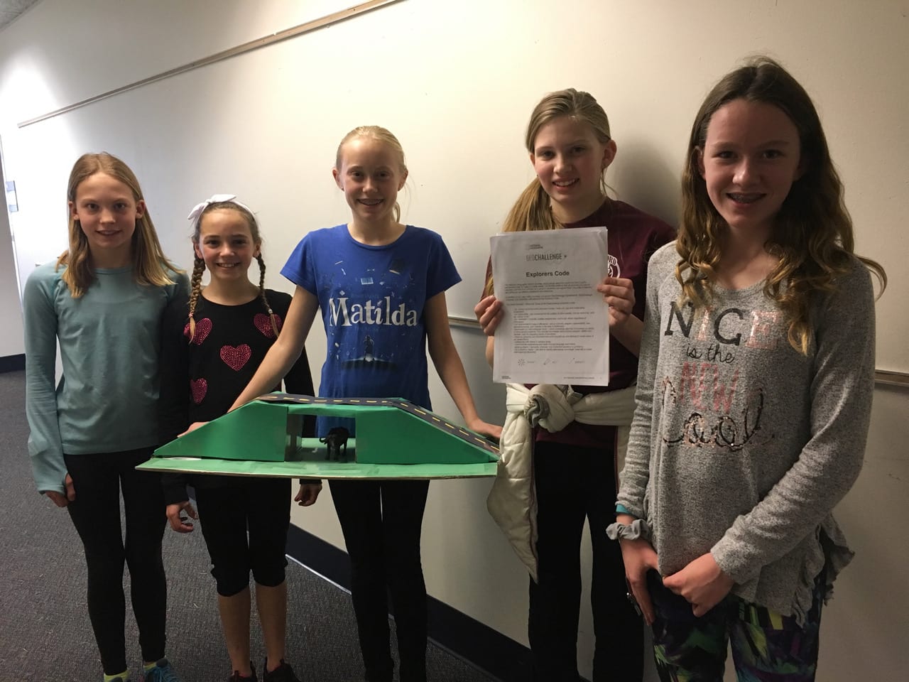 five students with their GeoChallenge STEAM project about wildebeests
