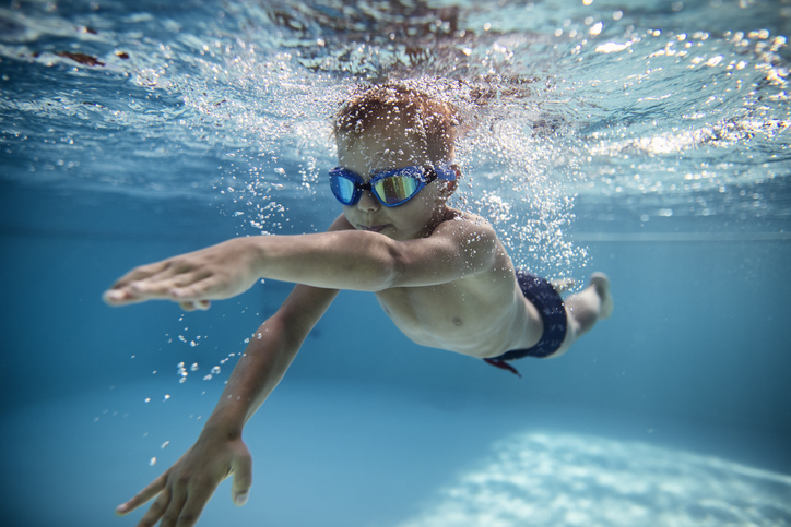 A small child is seen swimming underwater. 