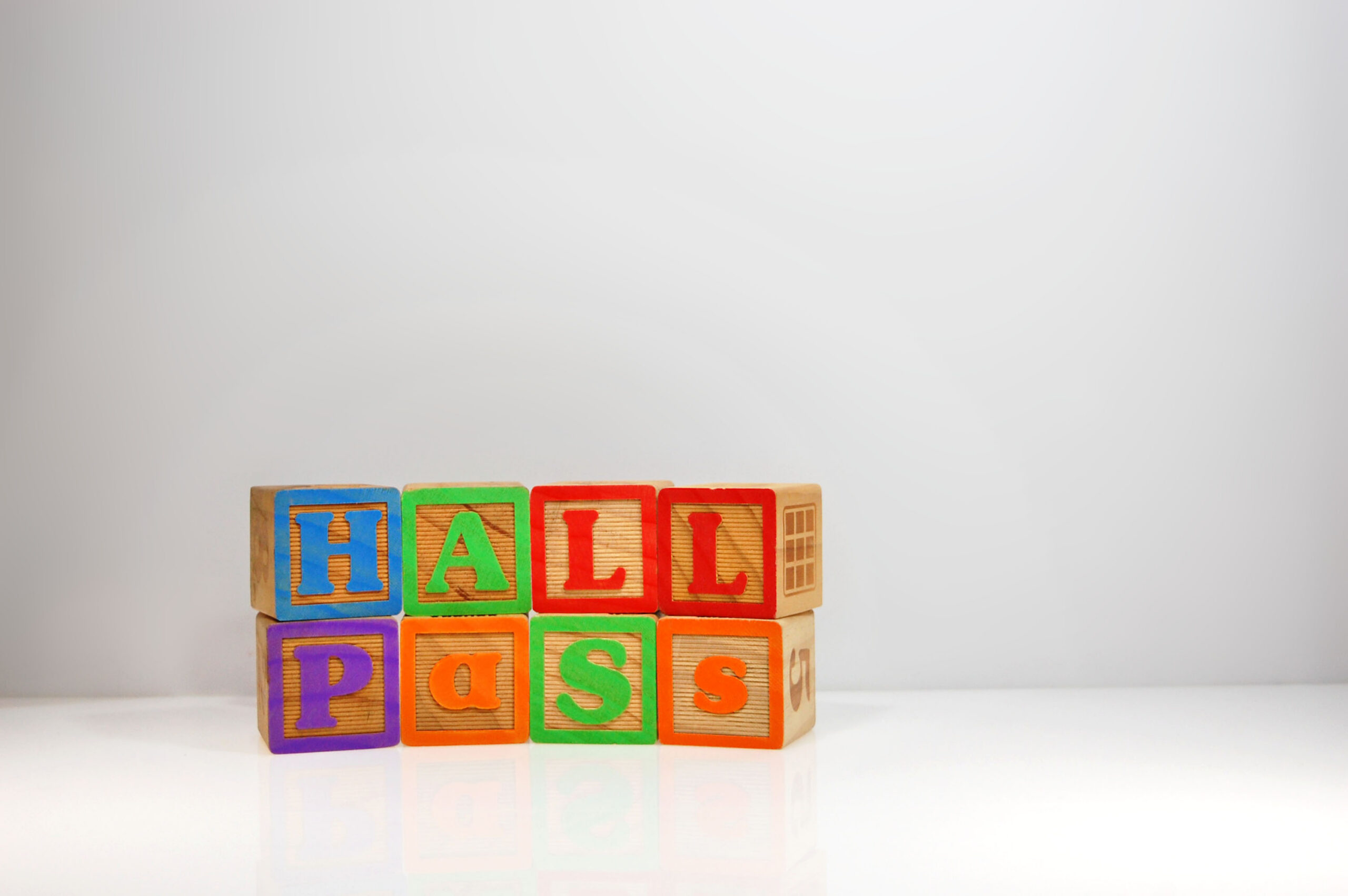 Stylized shot of "Hall Pass" spelled out with ABC blocks.
