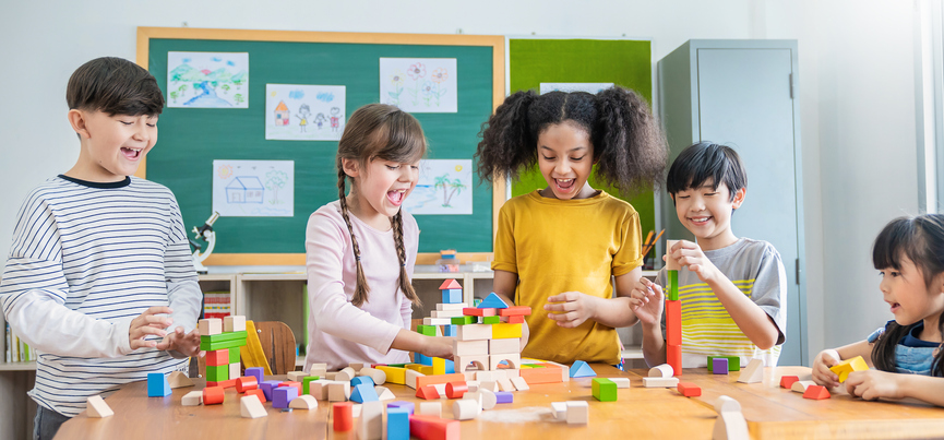 Cooperative games for kids include building with blocks like the children shown here.