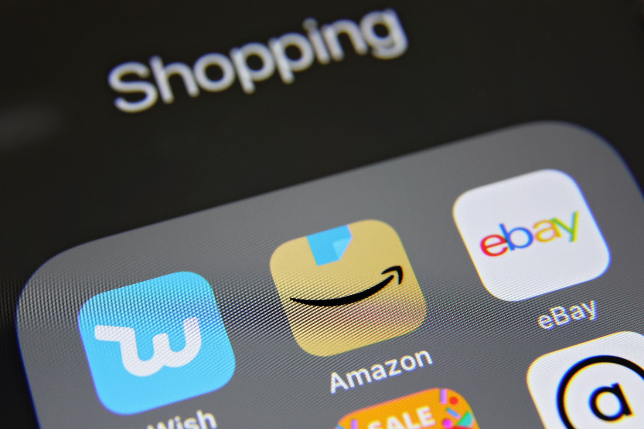 Apple iPhone 8 screen with Online shopping e-commerce mobile app icons applications Amazon, Ebay, AliExpress, Wish etc.