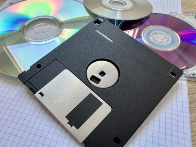 CD roms and floppy disks scattered on top of graph paper