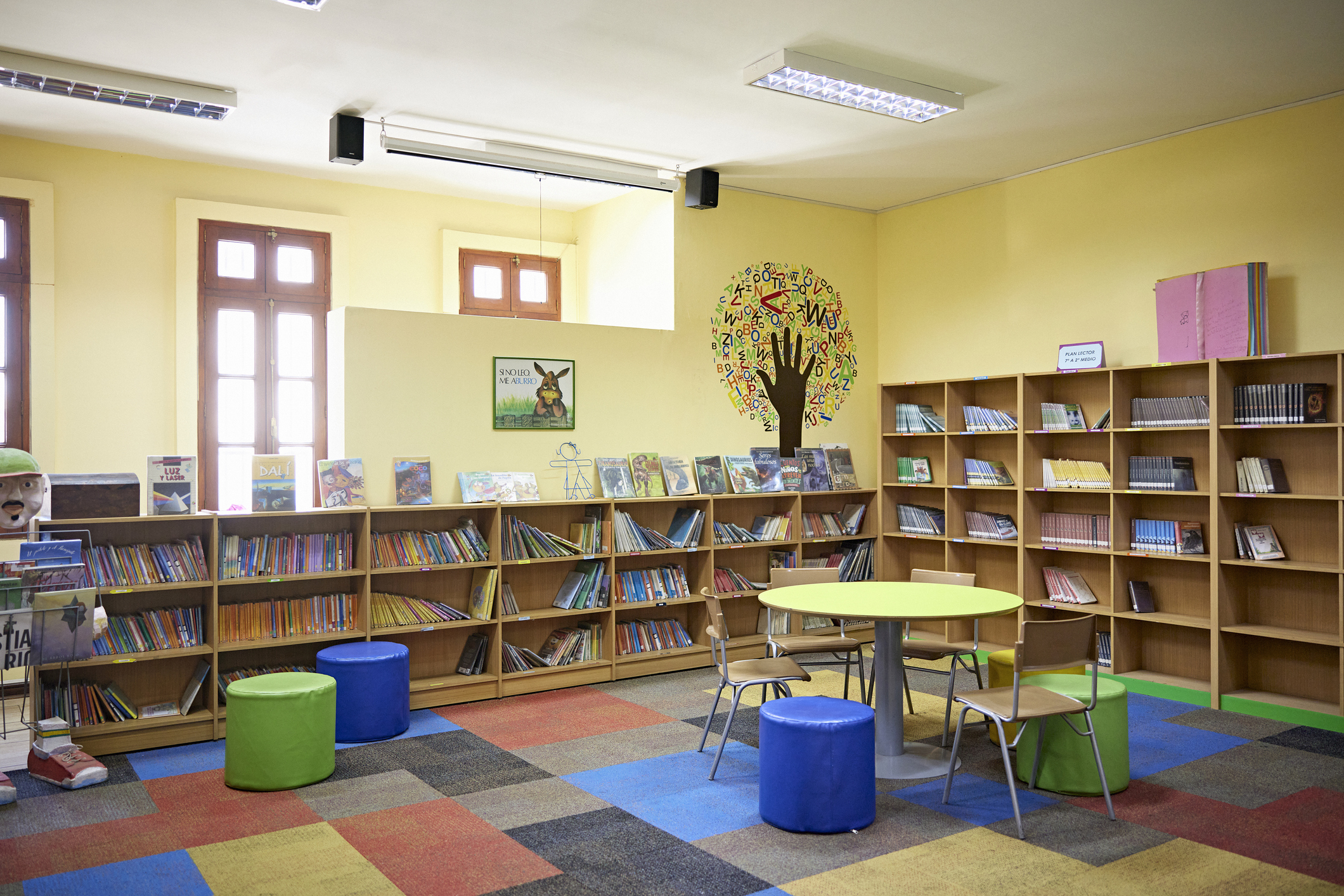 Bookshelves with literature, round table, and chairs for relaxed reading.