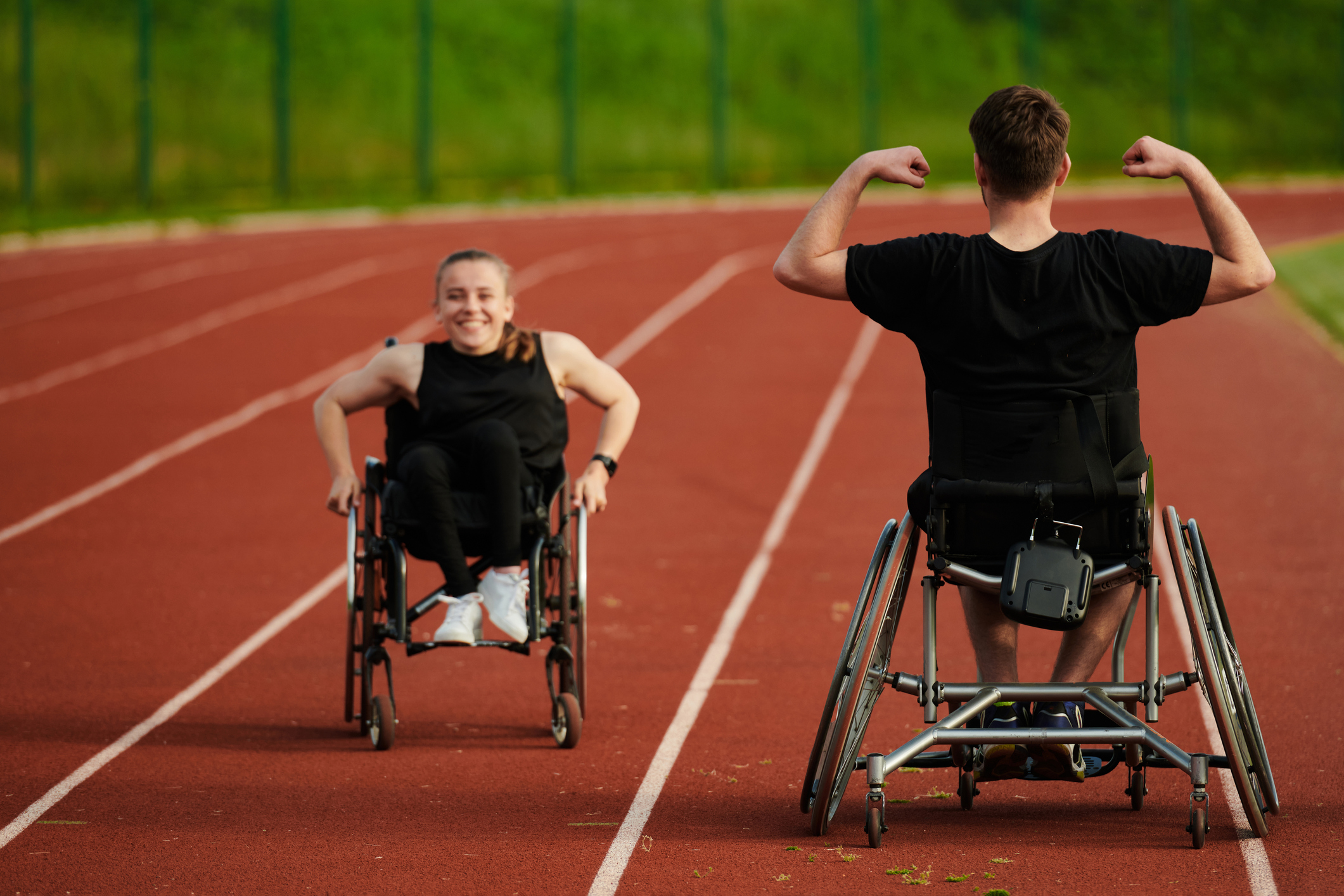 Strudents in wheelchairs train together on a track