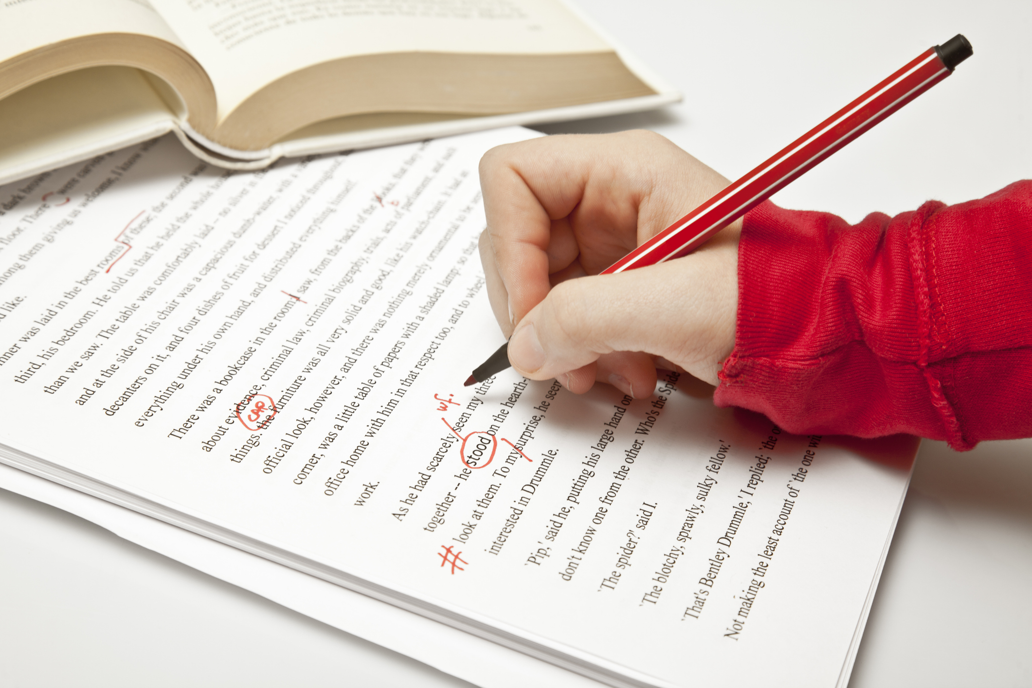 "Proofreader at work, working in a novel and using professional proofreader signs. Proofreading concepts Lightbox:"