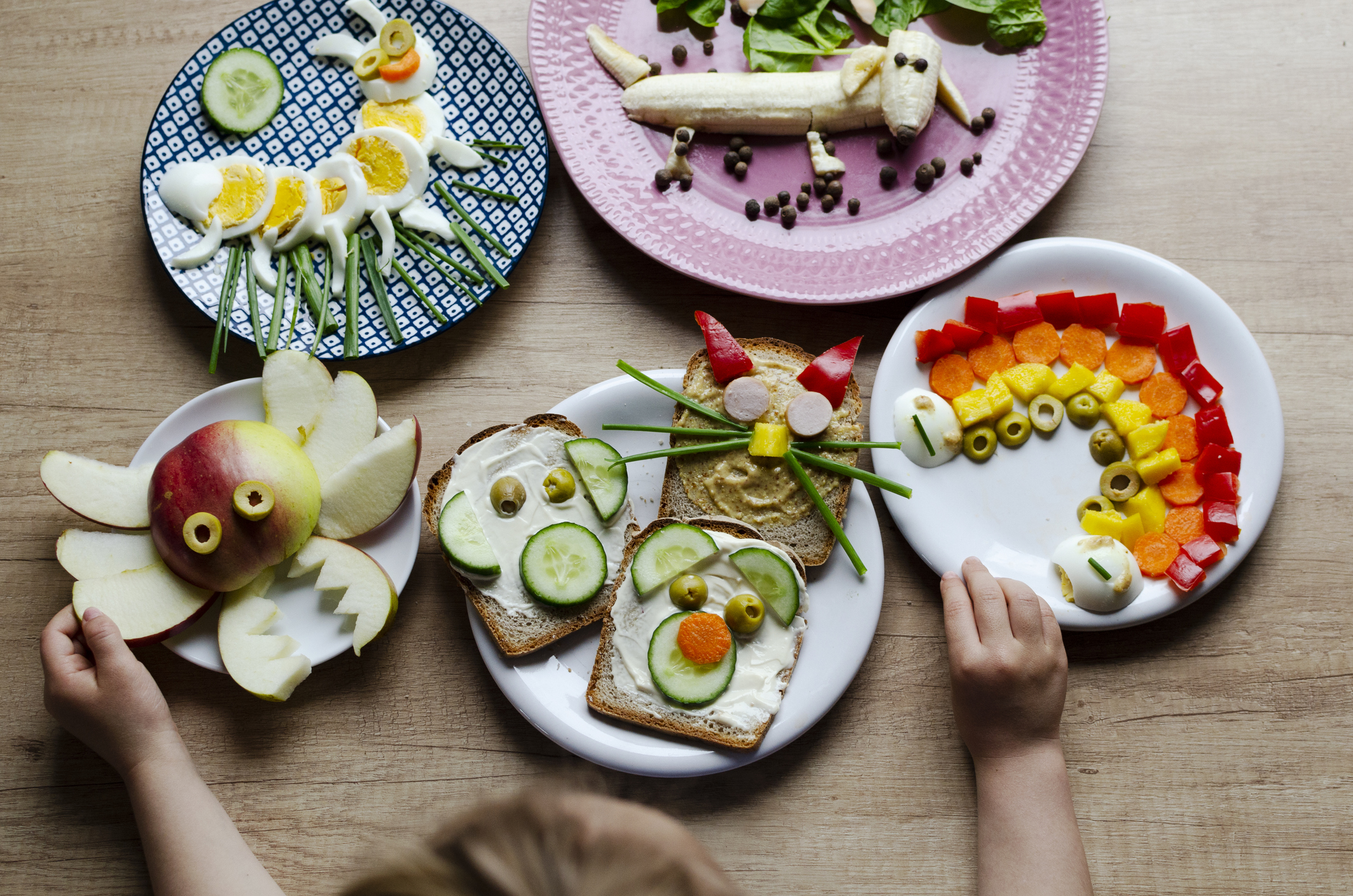 Multi coloured of funny food for child for breakfast. Healthy eating with decoration and creativity and fun in the kitchen. Table top view.