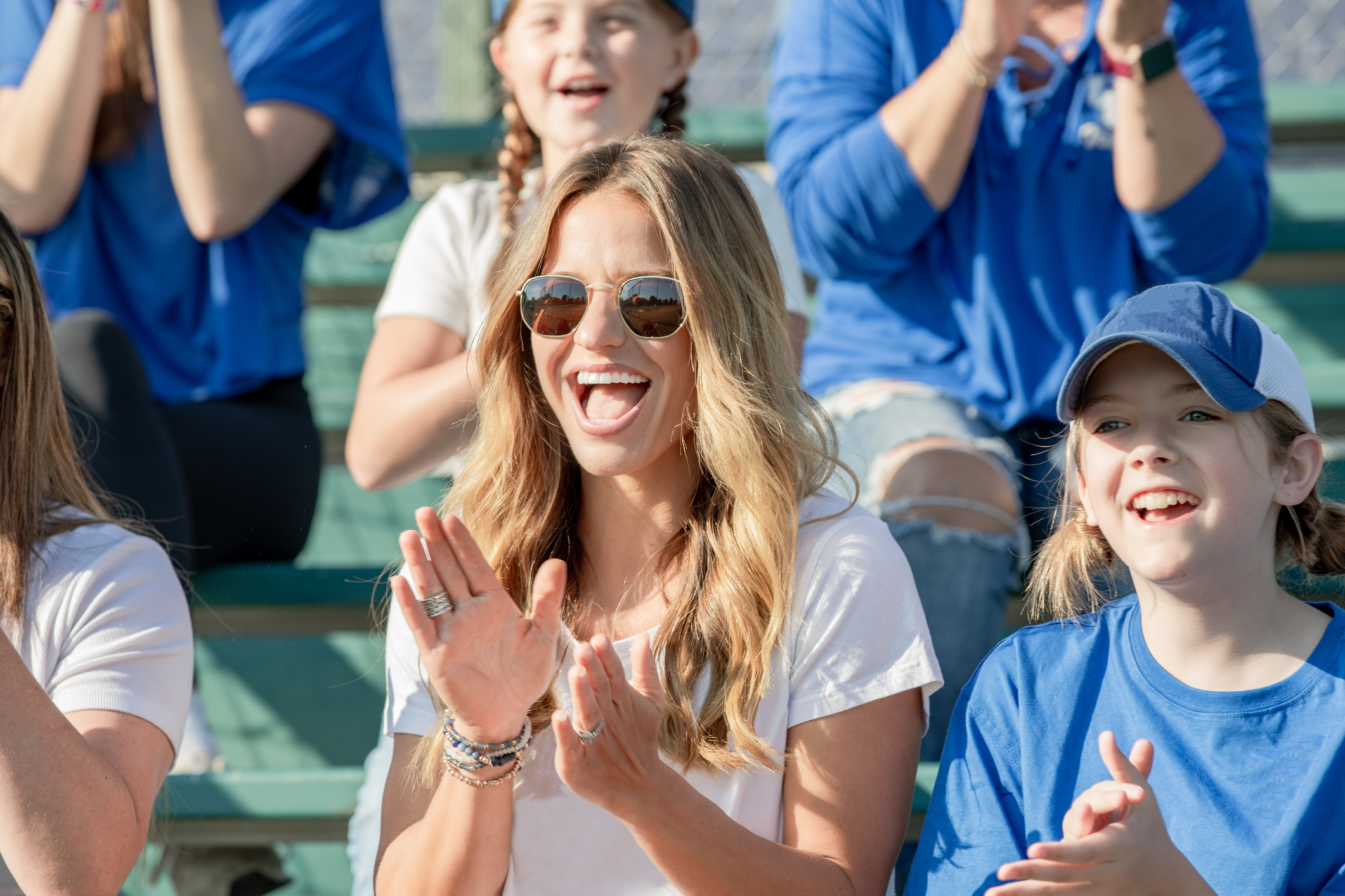 Woman attends college sports event with her daughter on sunny day
