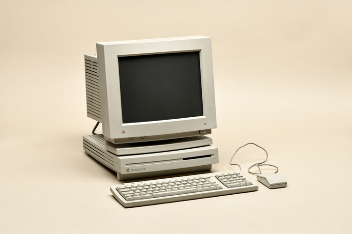 Milan, Lombardy, Italy - June 16, 2019 : Macintosh LC III from 1994. Retro personal computer manufactured by Apple Computer Inc. with monitor, keyboard and mouse, isolated on beige background