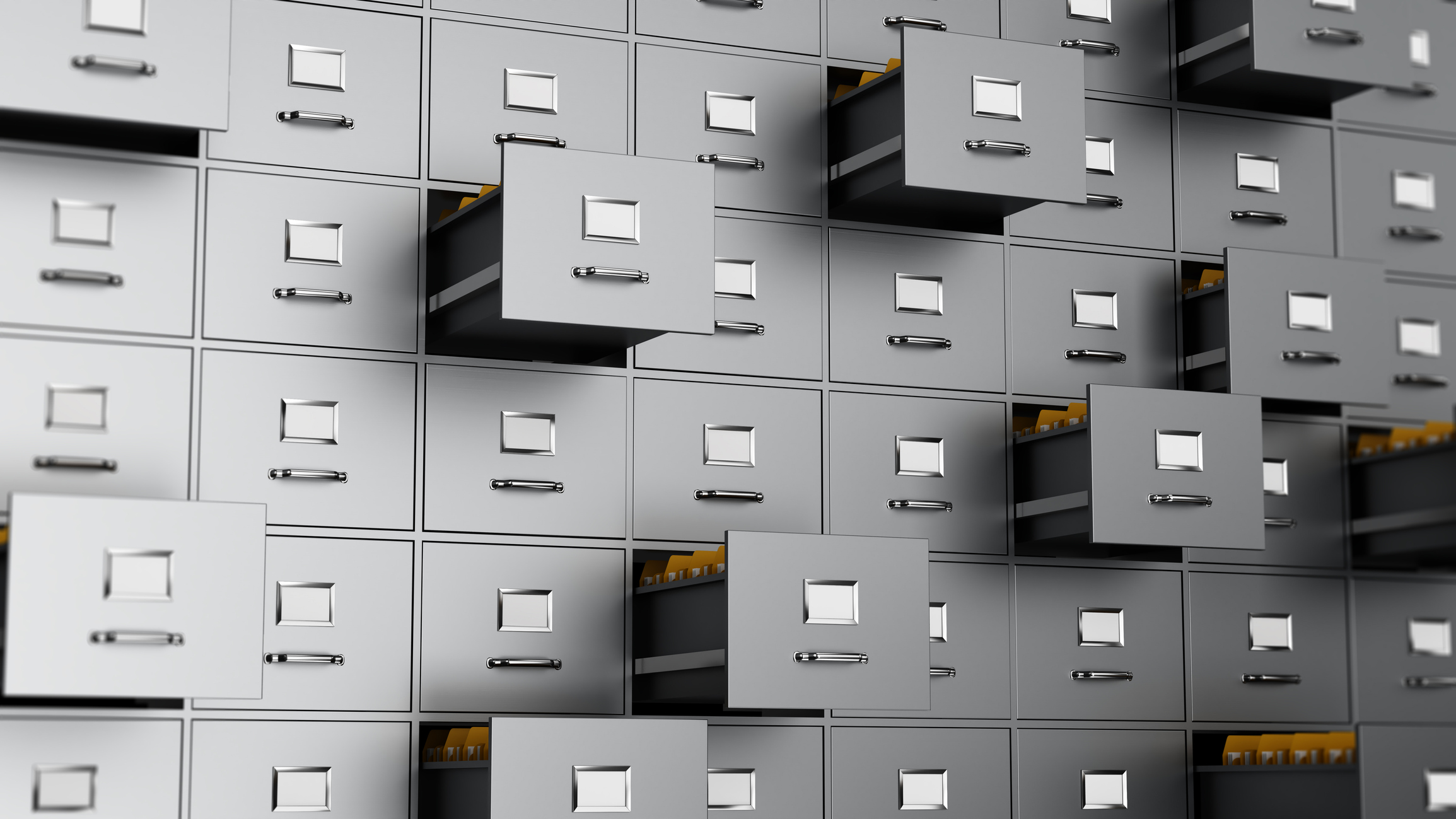 A close view shows a modern filing cabinet filled with gray drawers. Some drawers are open, revealing colorful folders. This showcases an organized workspace with efficient storage.