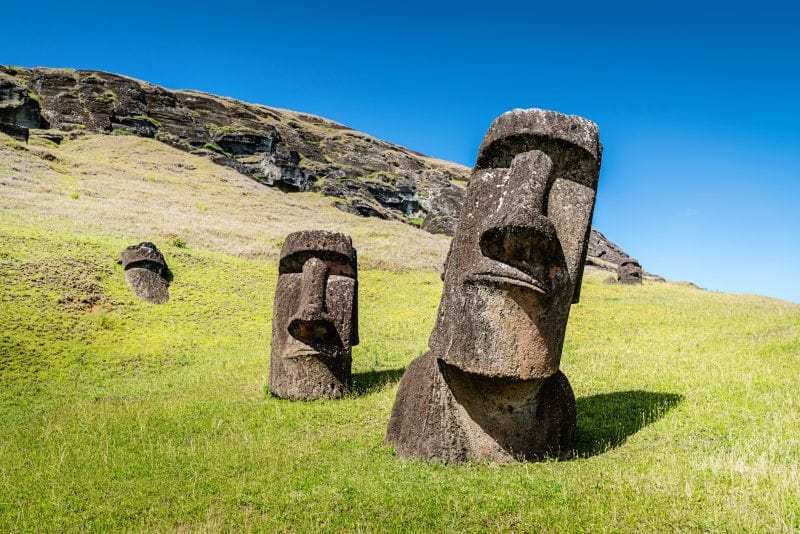 Easter Island Moai Statues at Rano Raraku under sunny summer sky. Rano Raraku, Rapa Nui National Park, Hanga Roa, Easter Island, Chile.