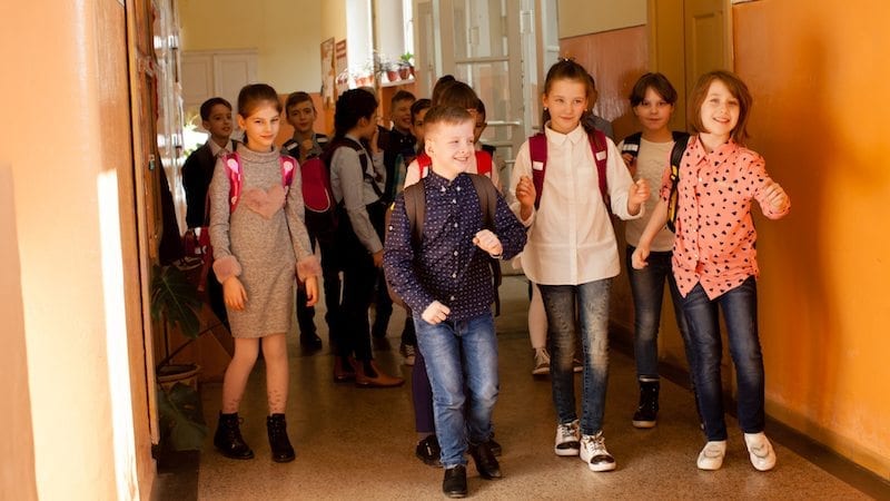 several kids in a school hallway