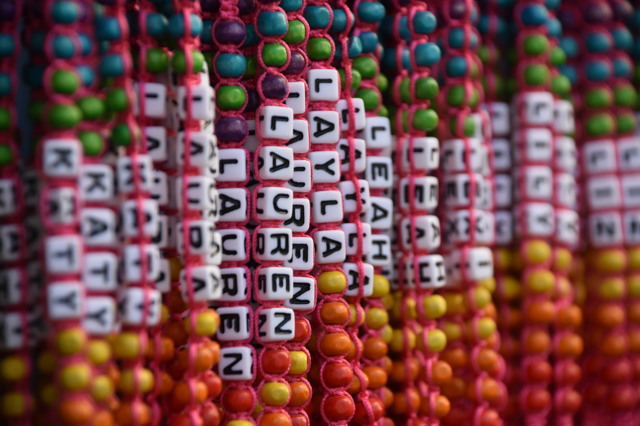 Beaded name bracelets hanging vertically