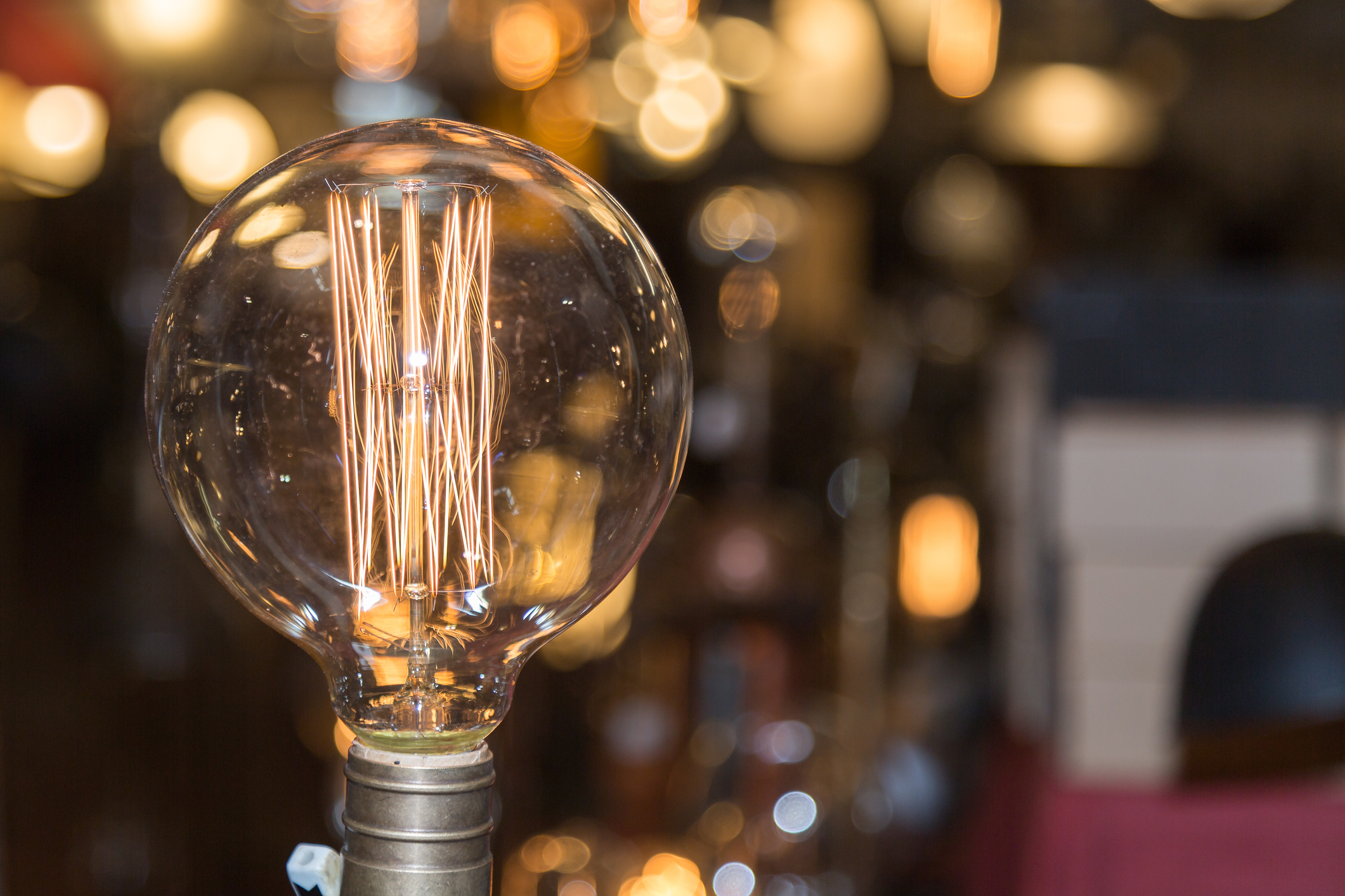 Single Vintage Electric Light Bulb with Incandescent Filament.