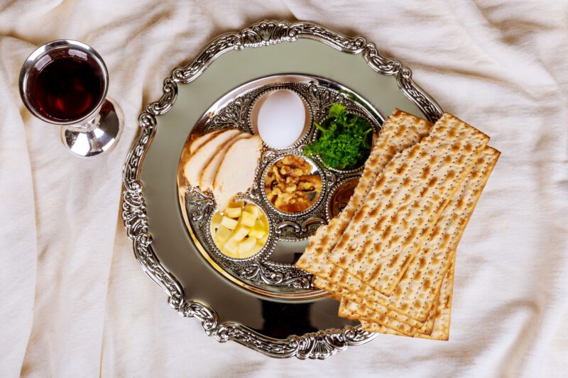 Pesah celebration concept jewish Passover holiday . Traditional pesah plate text in hebrew: Passover, egg,