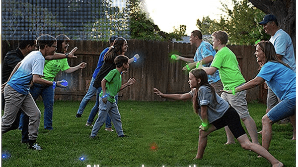 A family playing glow in the dark capture the flag outside