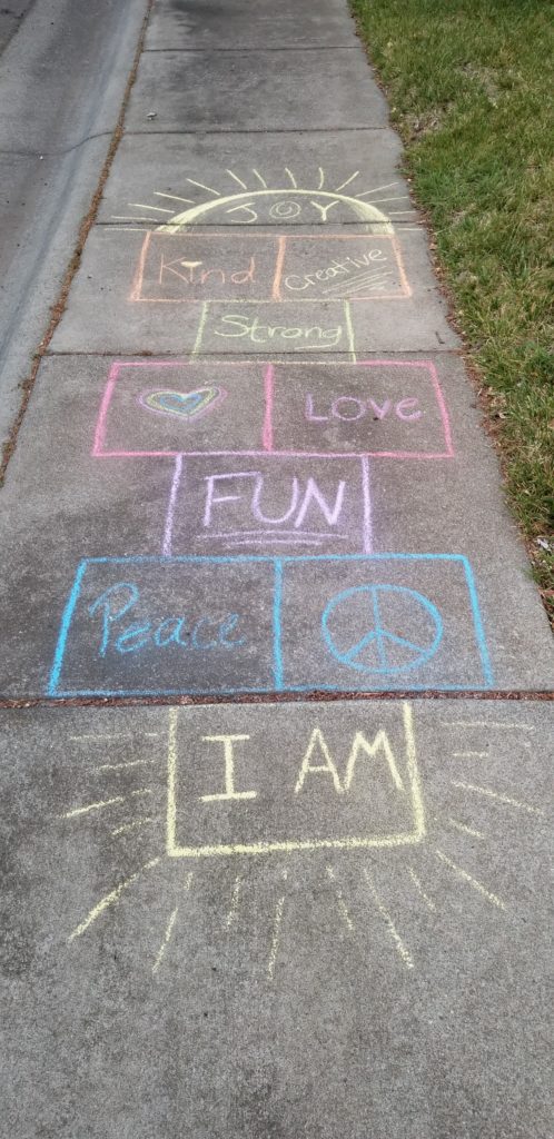 (Gratitude Activities for Kids) A hopscotch board is drawn on the sidewalk with chalk.