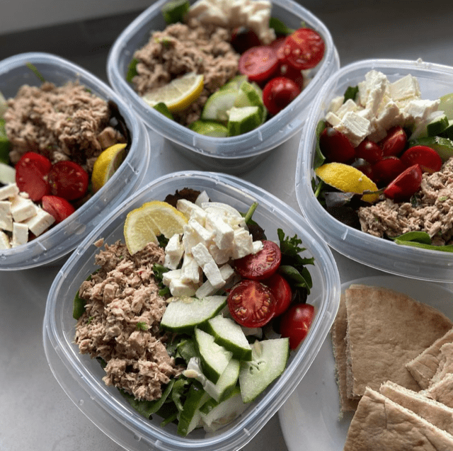 Four plastic containers filled with Greek-style tuna salad