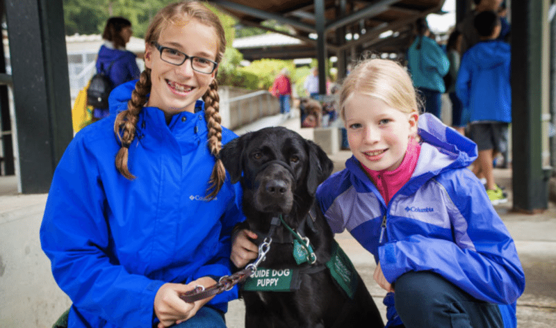 Two girls with guide dog puppy