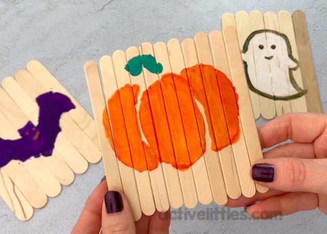Halloween themed puzzles made on wood craft sticks laid flat side by side