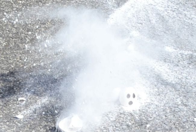 Eggshell painted with ghost eyes, dropped on the sidewalk in a cloud (Halloween Activities)of cornstarch (Halloween Activities)