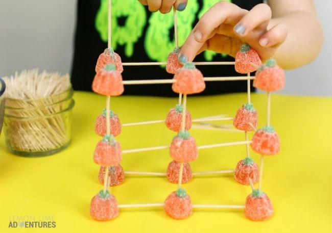 Student building a STEM structure with toothpicks and gummy pumpkins (Halloween Activities)