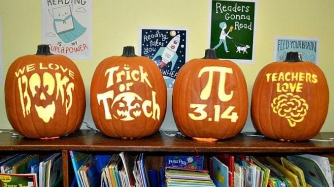 Jack-o-lanterns carved with education themed designs