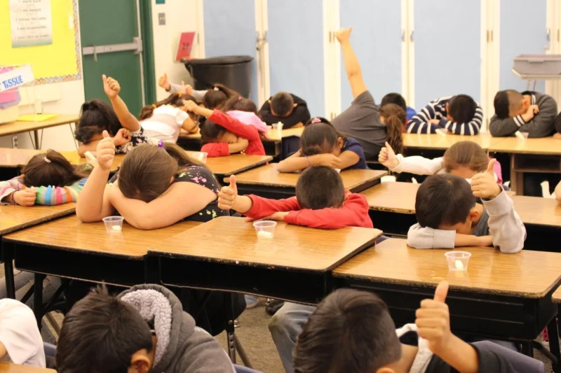 kids in the classroom playing Heads up, Seven up