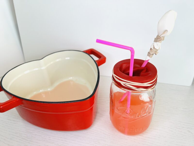 an image of a red heart pot, a jar and a straw to model how the circulatory system works