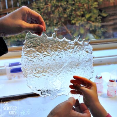 Child's hands holding a sheet of edible "glass" made of sugar