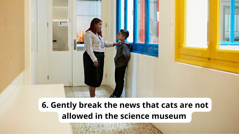 Teacher telling student cats are not allowed in the science museum