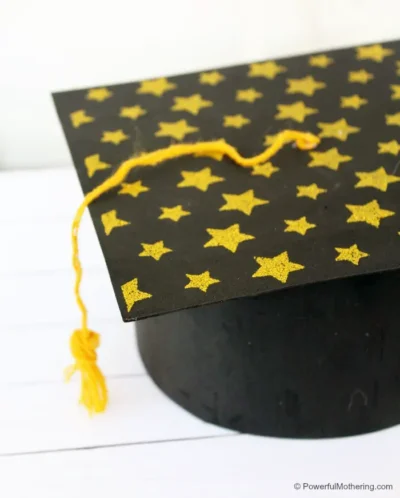 Close up of graduation cap decorated with yellow stars.