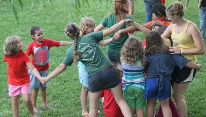 students holding hands twisted up into a human pretzel 