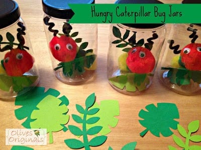 pom pom caterpillars are contained within glass jars.