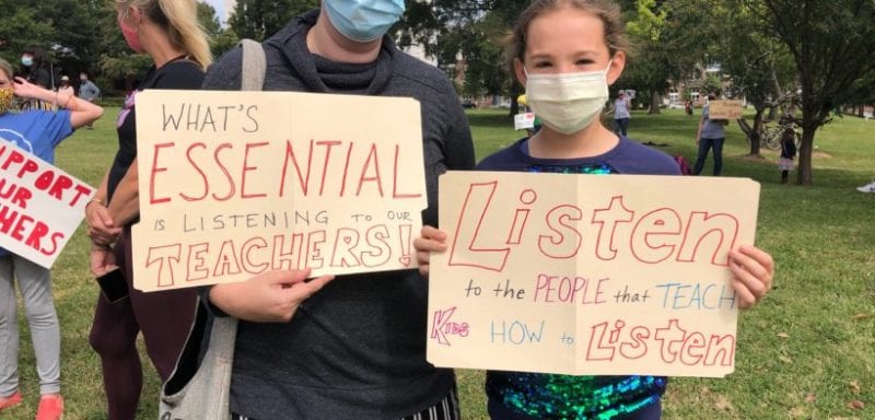 Children holding signs about listening to teachers