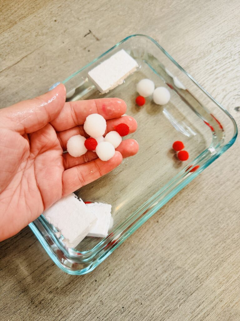 a sensory bin representing white and red blood cells