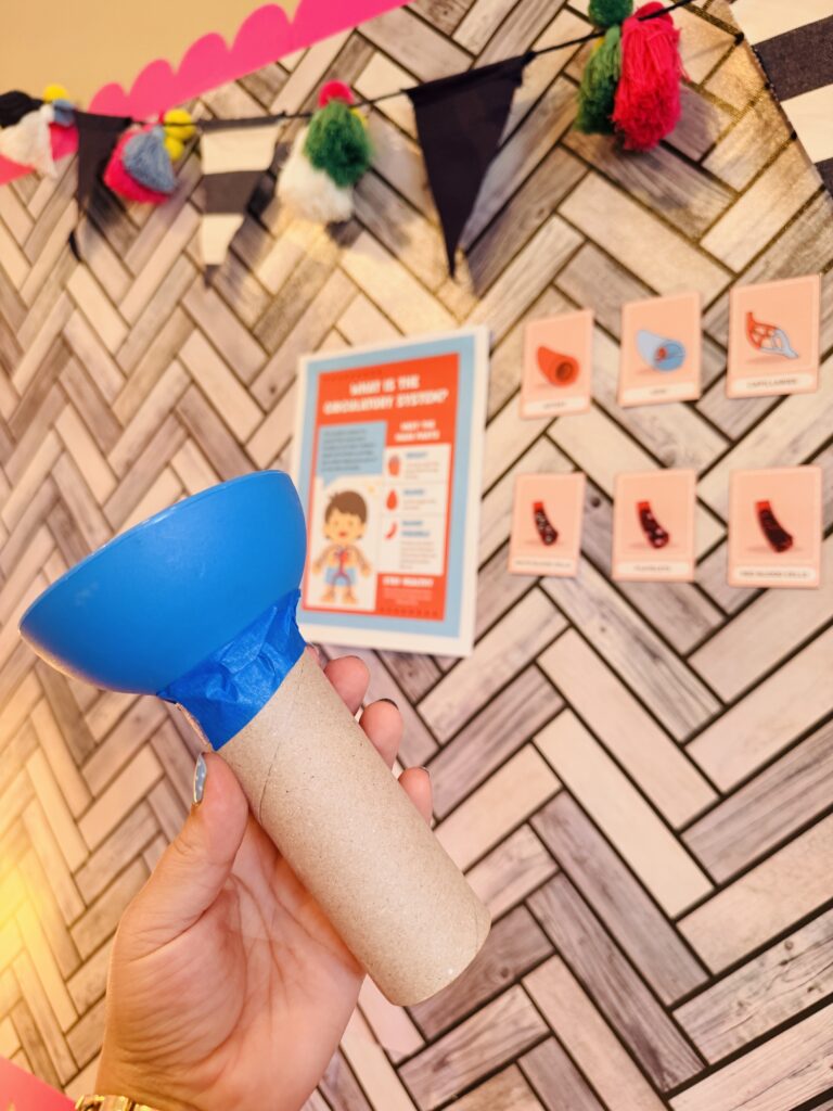 an image of a student created stethoscope made out of a paper towel roll 