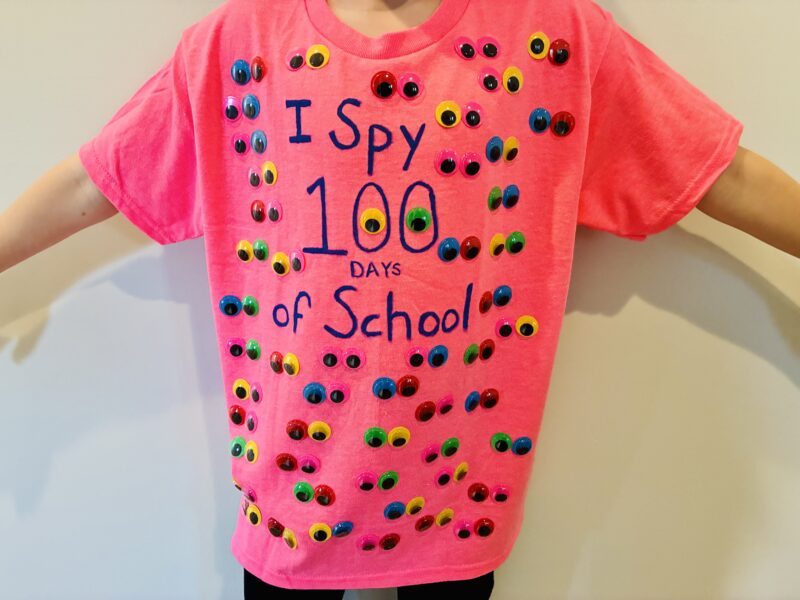 a student wearing a neon pink shirt with the words 