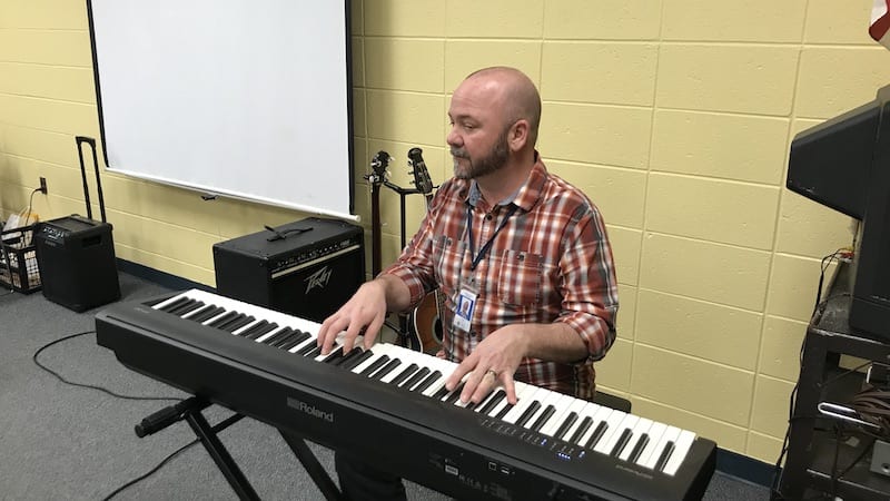 Music teacher plays keyboard as part of Carnegie Hall Musical Explorers program