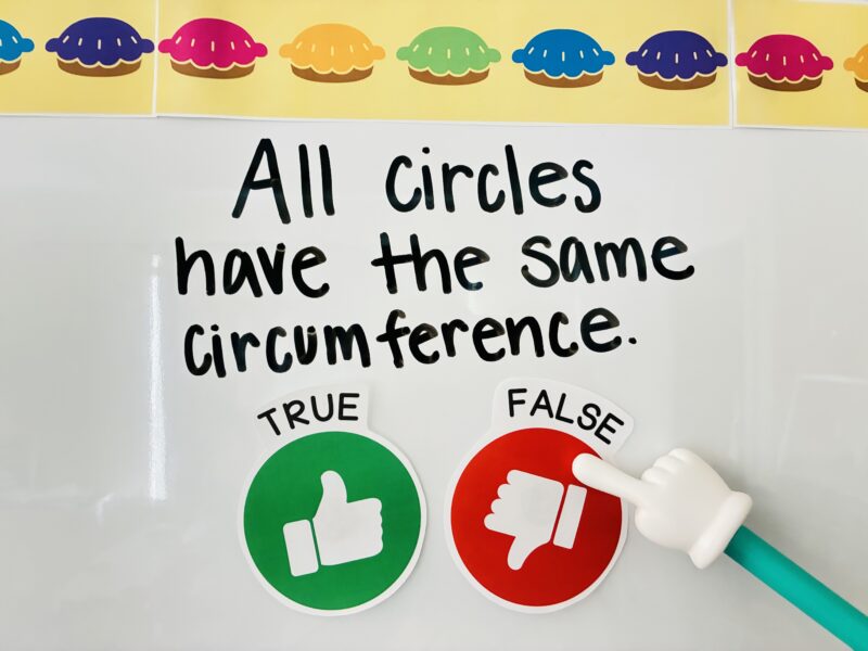 a true and false statement written on a white board with a green thumbs up and a red thumbs down