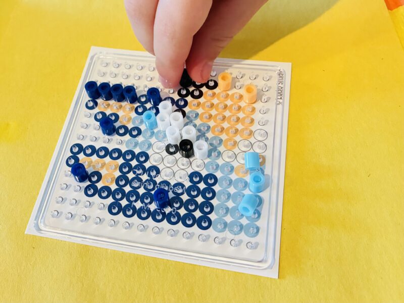 an image of a fine motor activity that involves students making perler bead creations