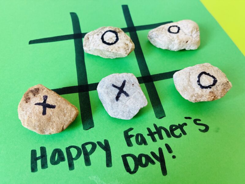 a Father's Day tick tack toe game made with stones