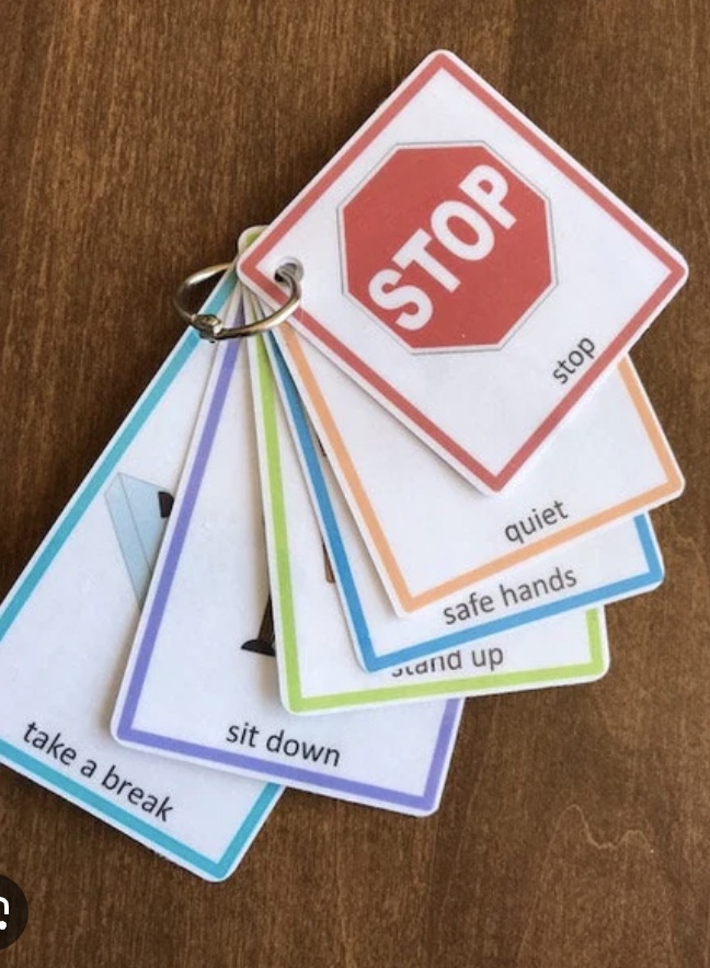 visual pictures for rules. card with stop sign on top.