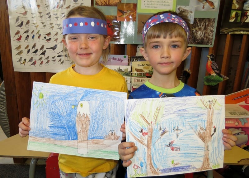 Two students showing Bird drawings