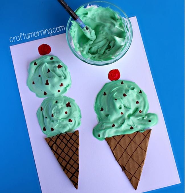 Paper ice cream cones topped with shaving cream dyed green