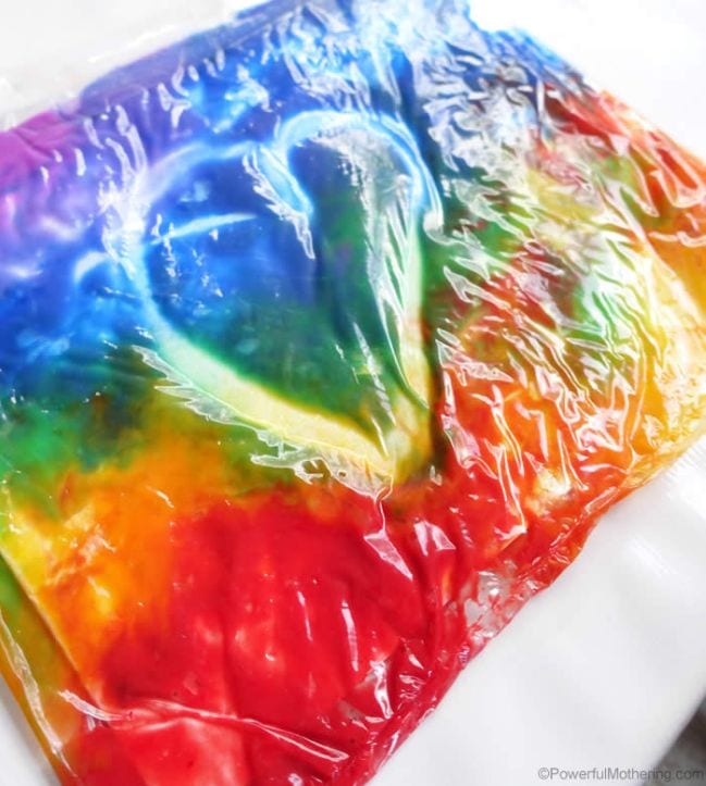 A rainbow of paints inside a sealed plastic bag, with a heart shape drawn on it (Kindergarten Art)