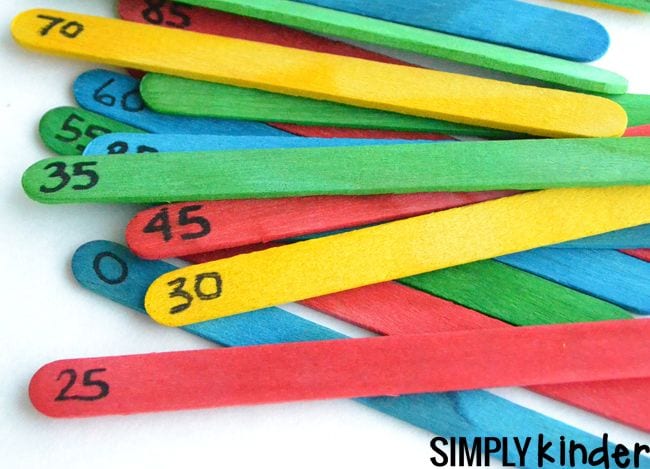 Colorful wood craft sticks with fives numbers written on one end, used for kindergarten math games