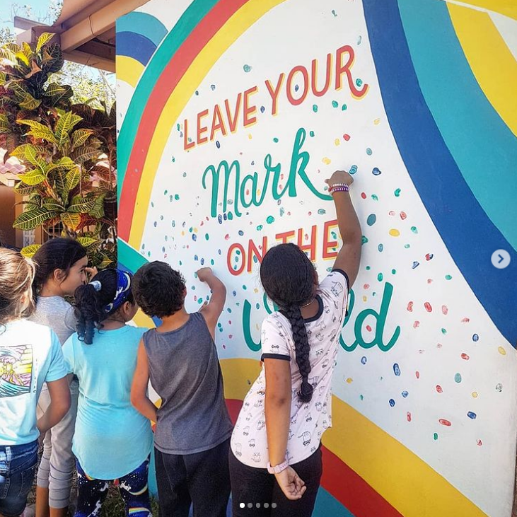 Students adding their fingerprints to a school mural