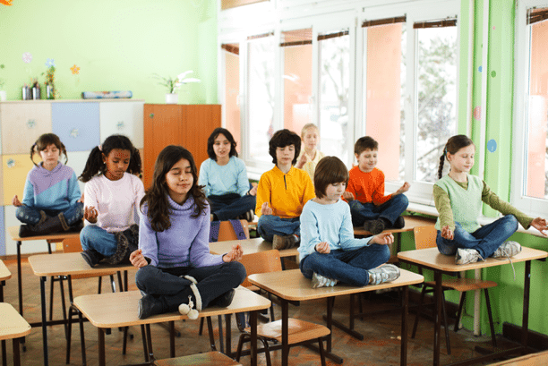 Students meditating at desks