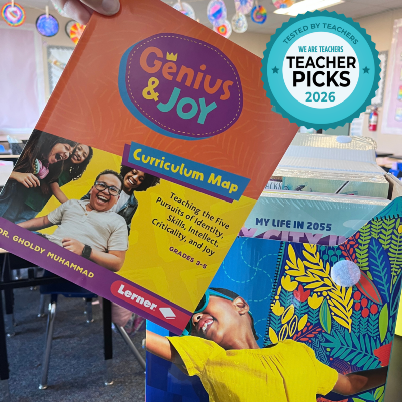 Lerner Genius & Joy – Curriculum Map and Box in Classroom Teacher holding up Genius & Joy curriculum in classroom.