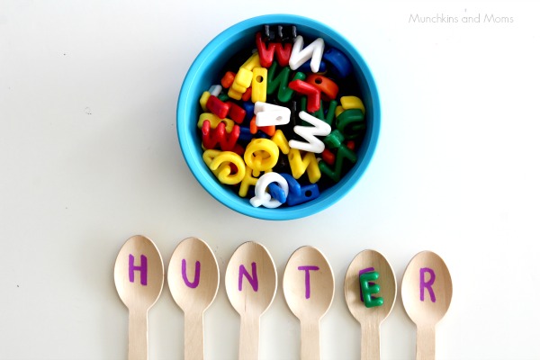 The name "Hunter" spelled out on spoons with individual letters of the name written on each with a bowl of colorful letters, an example of reading activities